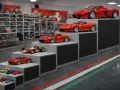 Una tabella scala modellismo auto Ferrari, con modelli di diverse dimensioni disposti su gradini.