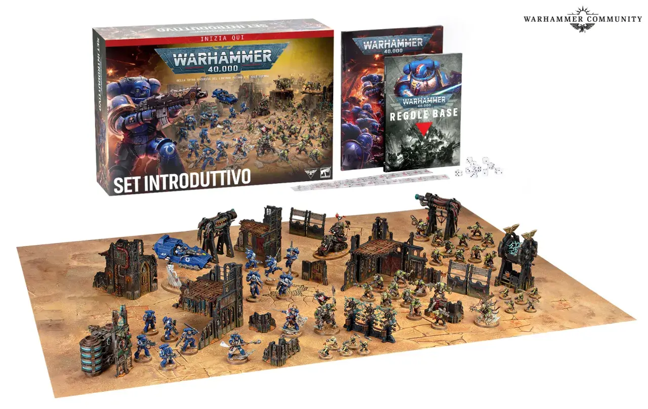 Il set introduttivo di Warhammer gioco da tavolo presenta Space Marine e Orki su un campo di battaglia con rovine e dadi.