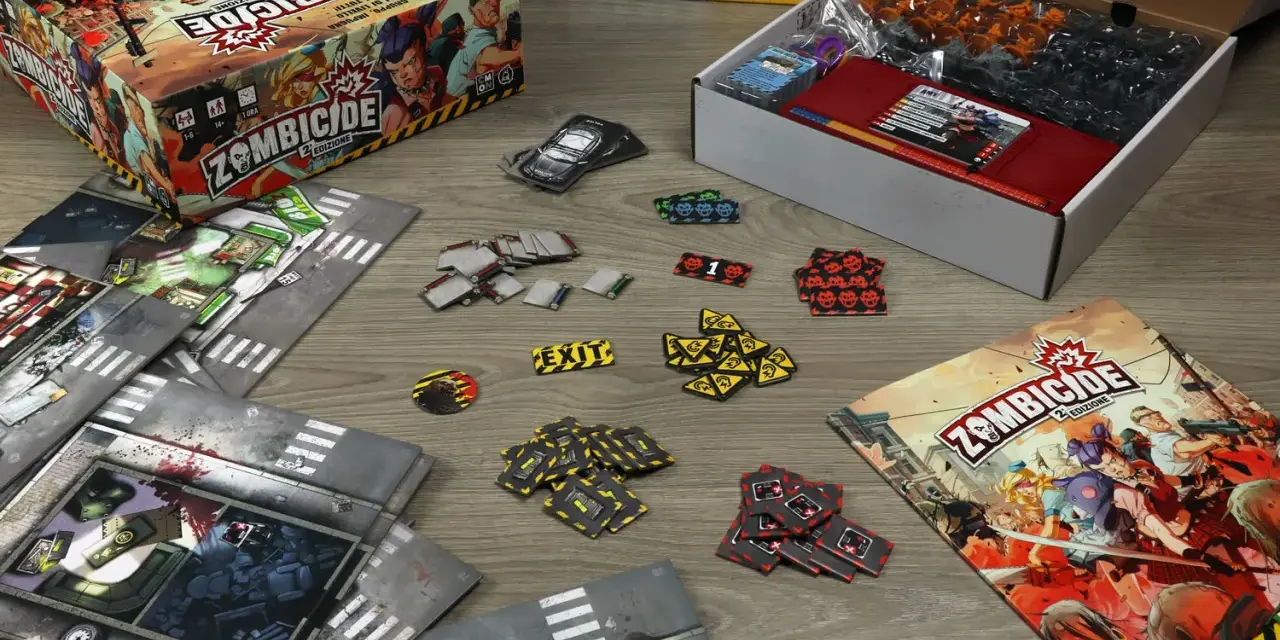La scatola di Zombicide 2ª Edizione, plance modulari, miniature e segnalini pronti per una recensione avvincente.