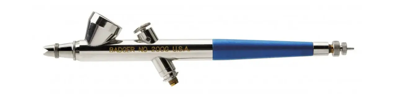 Aerografo Badger con serbatoio superiore e impugnatura blu. Ideale per imparare come usare aerografo per dettagli precisi.