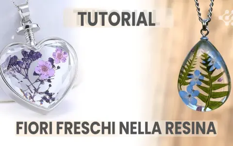 Ciondoli a forma di cuore e goccia con fiori freschi nella resina, perfetti per un tutorial creativo.
