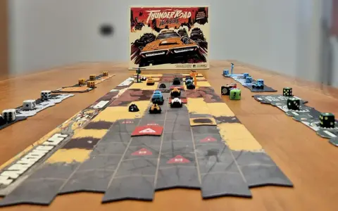 Il gioco da tavolo "Thunder Road Vendetta" è pronto per una folle corsa. Dadi e macchinine colorate sul tavolo.