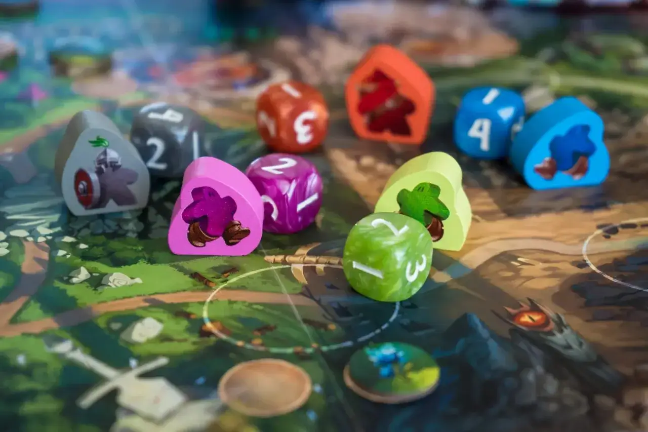 Pedine colorate e dadi su una mappa da gioco, pronti per un'avventura di dungeons and dragons.