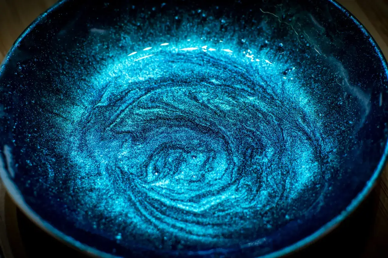 Effetto vorticoso blu intenso creato con pigmenti in polvere come si usano per dare profondità e brillantezza.